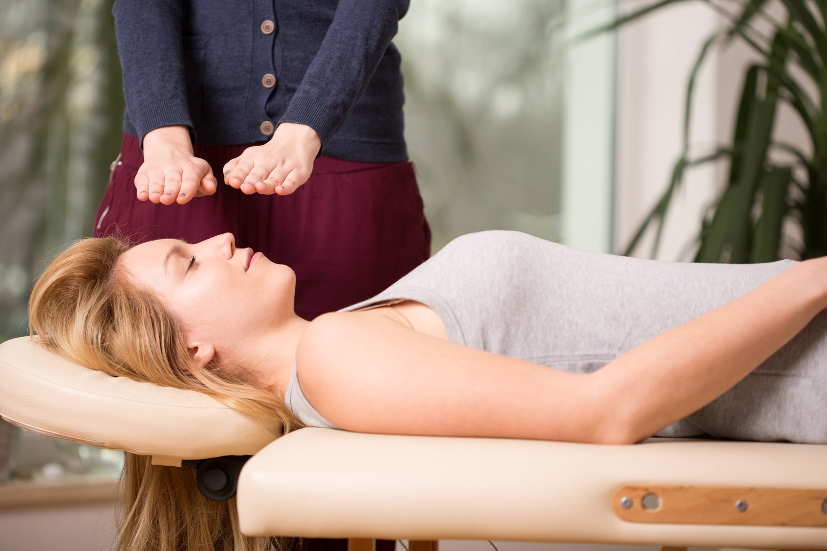 Young woman relaxing during bioenergy therapy session