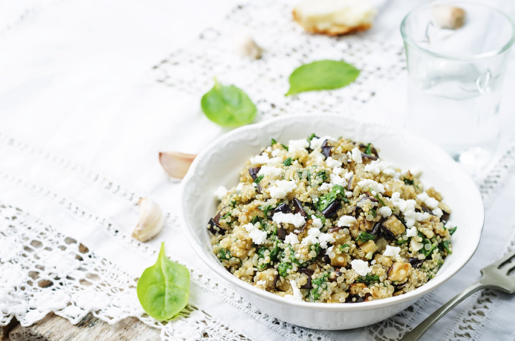 quinoa spinach eggplant feta salad on a white background. the toning. selective focus