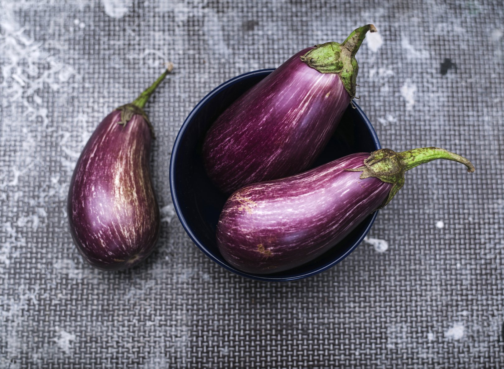 Healthy and delicious purple eggplants on vintage background